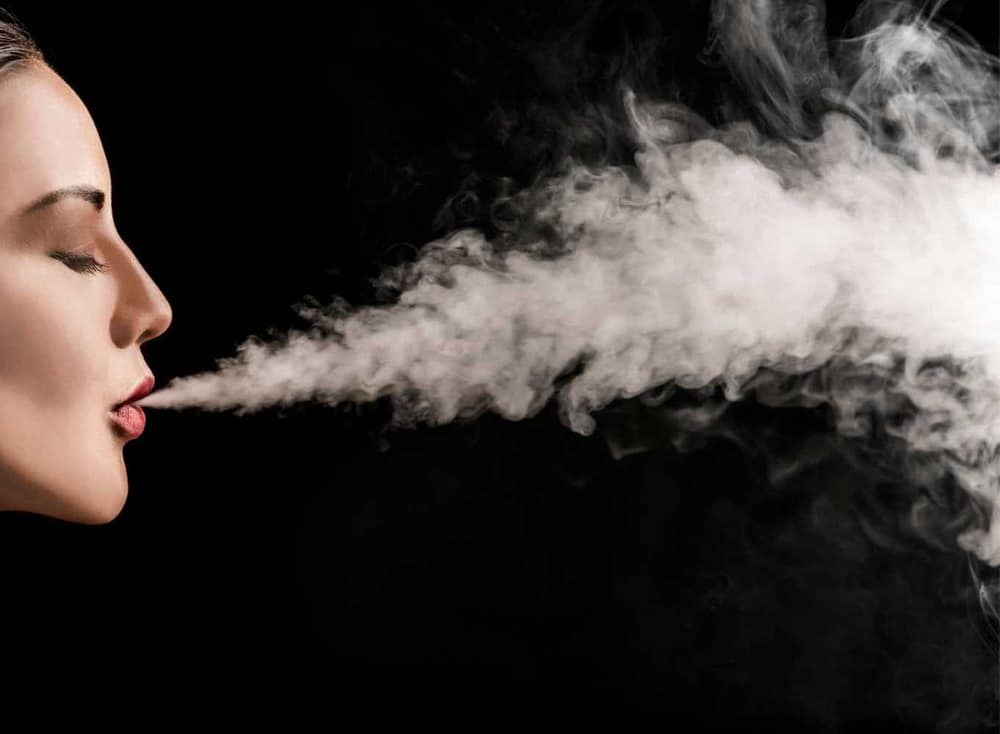 girl blowing smoke