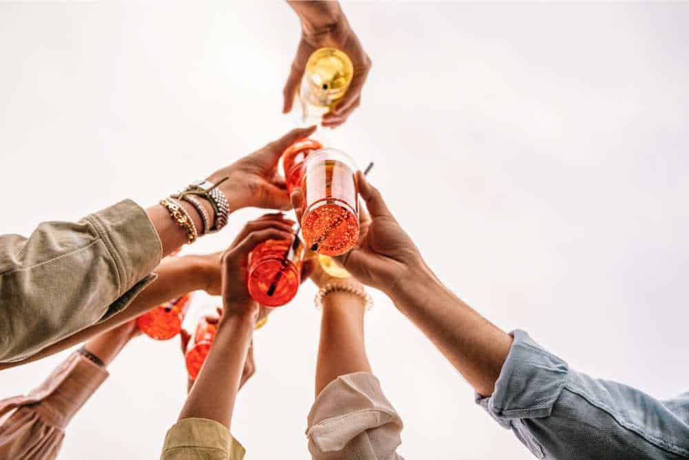people doing cheers with thc infused drinks